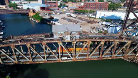 Above-View-Of-Freight-Train-On-Old-Rusty-Bridge-Passing-Over-River