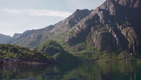 Rocky-Mountain-Slope-Reflections-On-Quiet-Lake-During-Summertime-In-Norway