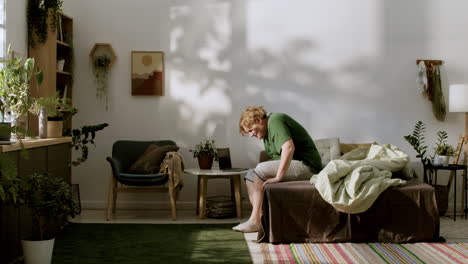 young man waking up and sitting