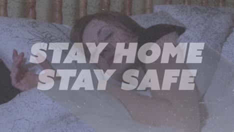 animation of text stay home stay safe over caucasian woman sleeping