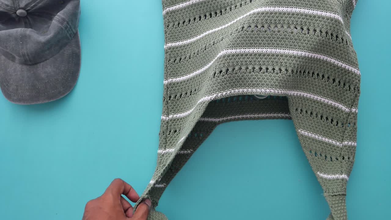 Overhead shot of bag, lunch box, and cap