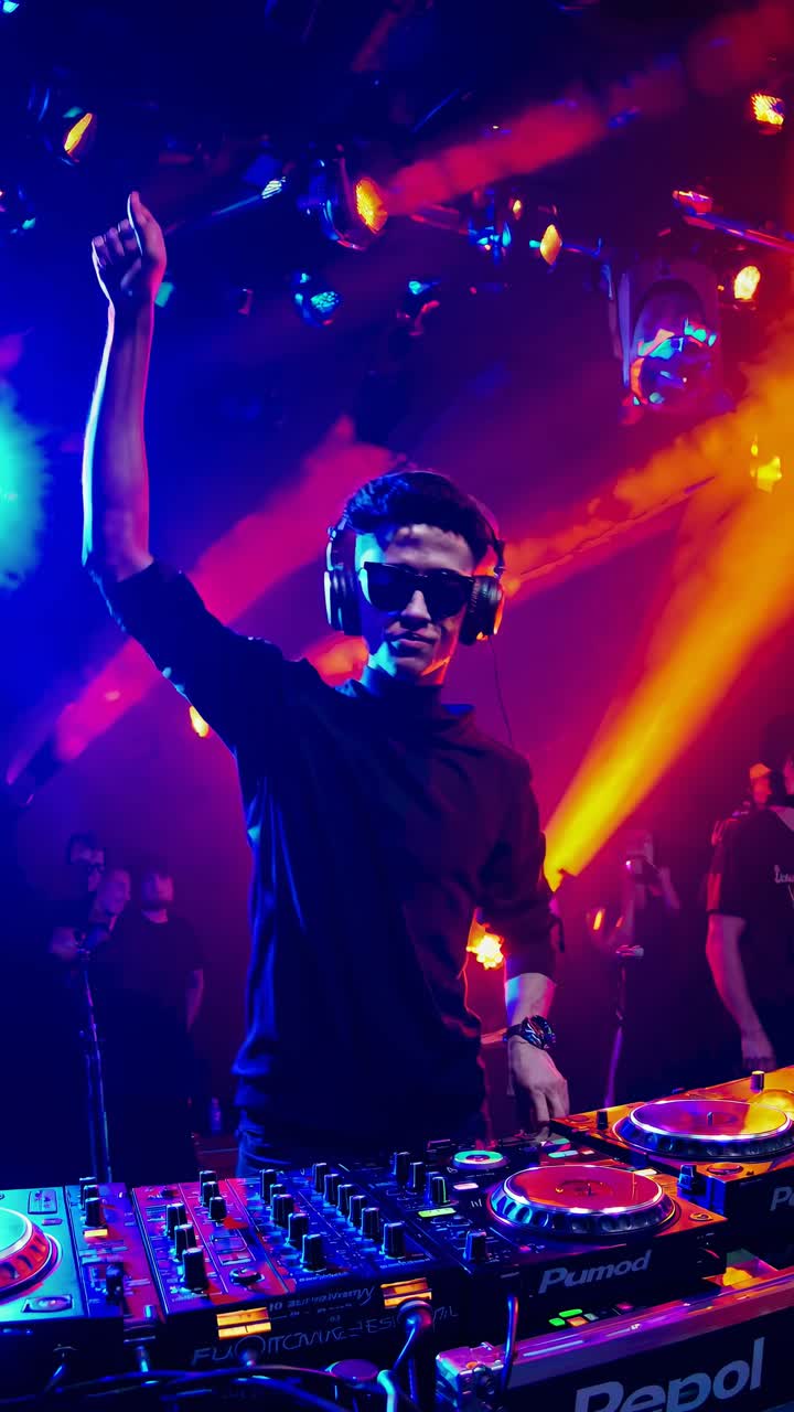 DJ performing at a vibrant club with colorful lights, captured from a low-angle