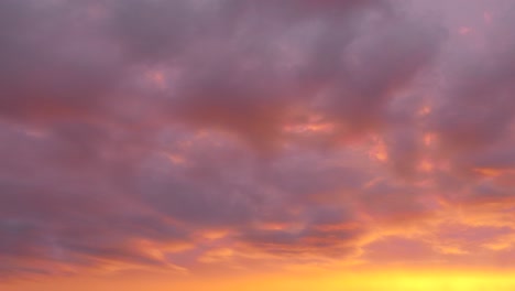 hermosas nubes de fucsia rosadas moviéndose rápidamente vistas en un time-lapse al anochecer