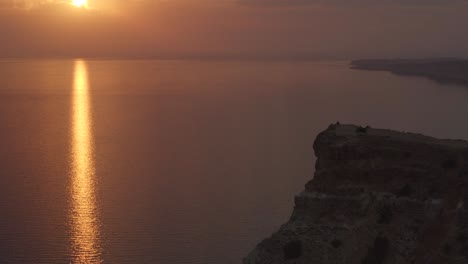 sunset over a cliff