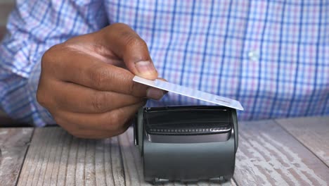 person using a credit card at a pos terminal