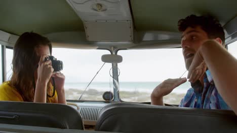 woman clicking photo of man in camper van 4k