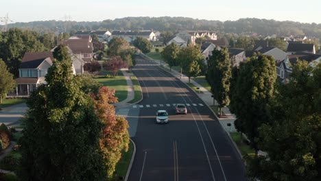 aerial of traffic driving through residential suburban community in usa