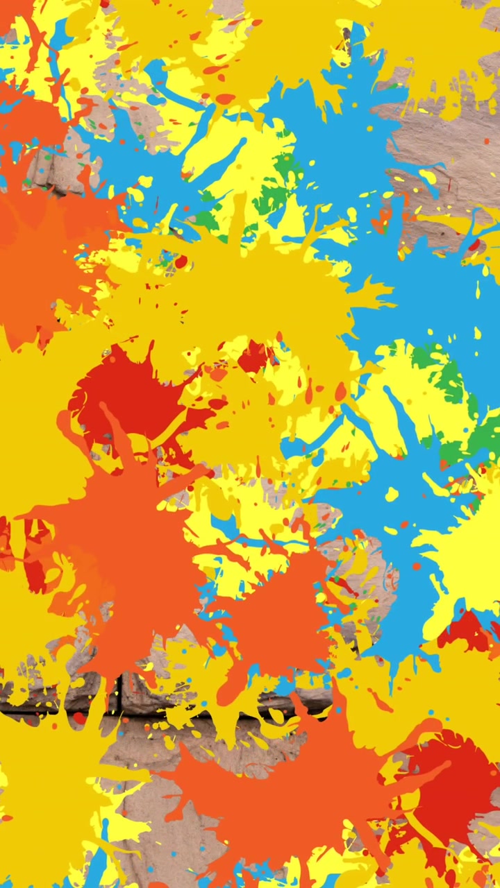 Animazione di diverse macchie colorate su un muro di mattoni
