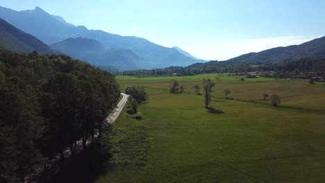 Forward-drone-shot-of-a-road-surrounded-by-fields,-near-Kobarid,-Slovenia