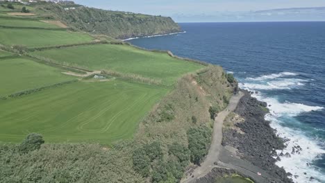 rocky coast and green meadows of santo antonio, sao miguel island