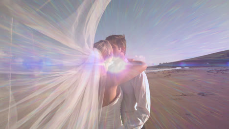 animation of light moving over happy caucasian newly married couple on beach