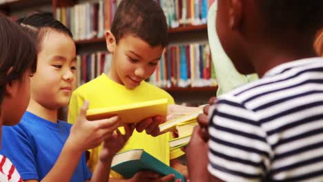 Teacher-passing-out-books-in-library