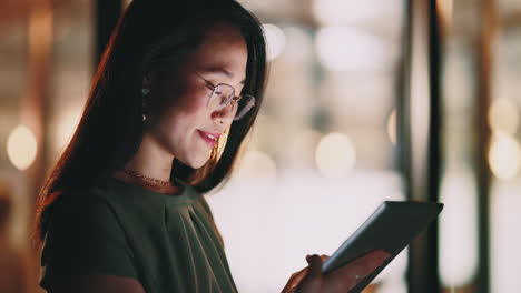 Asian-woman,-tablet-and-typing-in-night-office