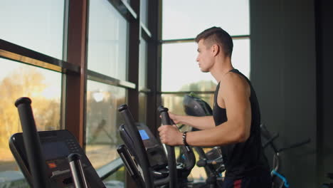 man on elliptical fitness equipment