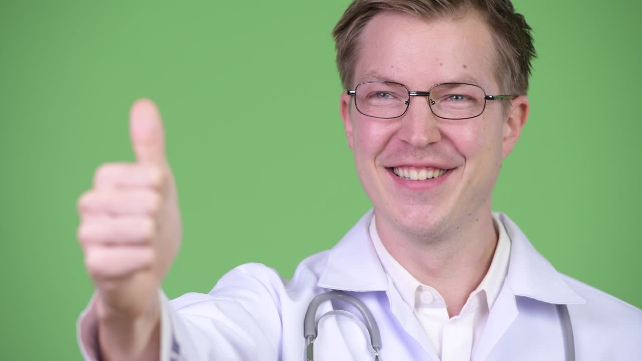 Young Man Doctor Making Thumb Up Gesture