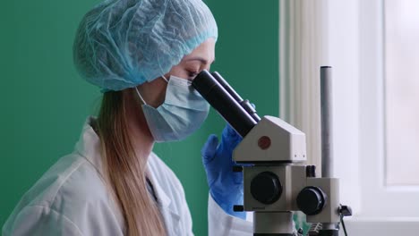 scientist using microscope in laboratory