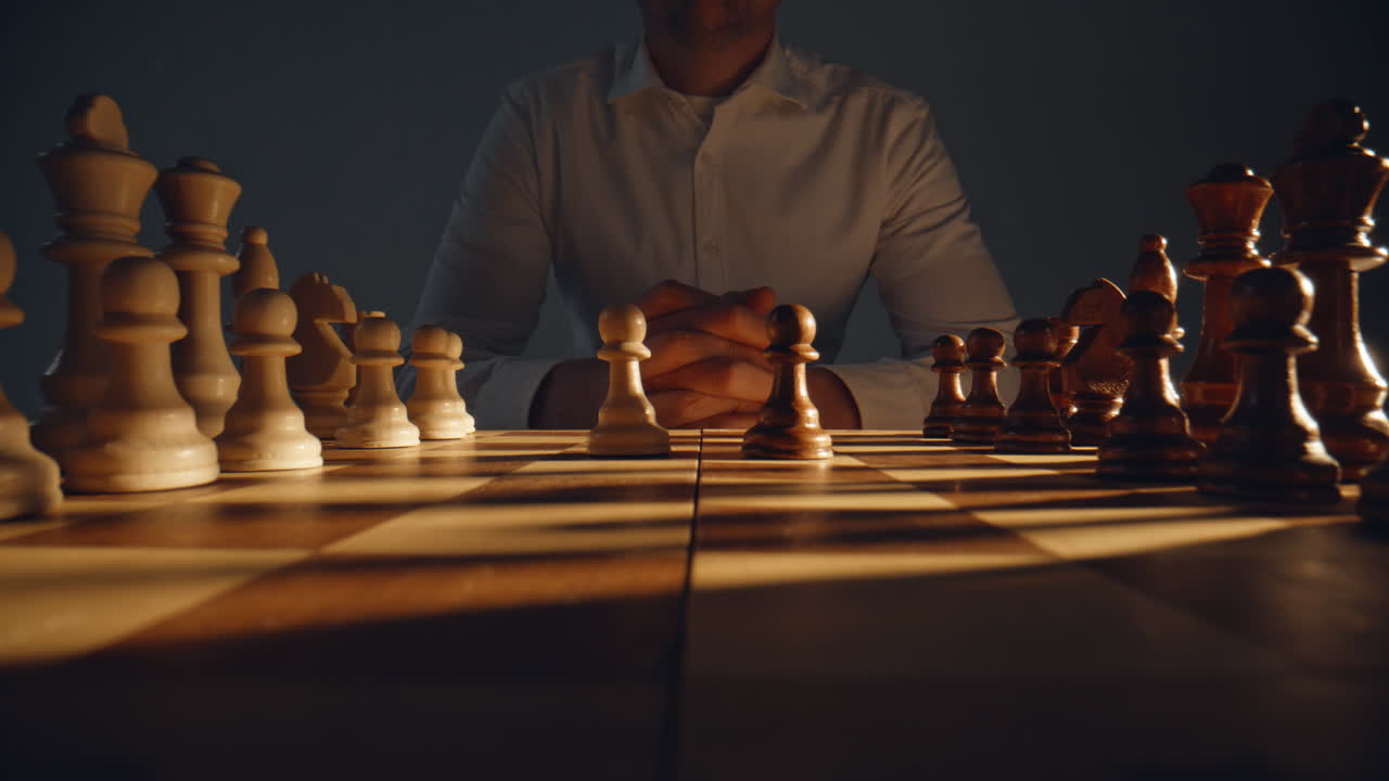 Unknown chess player sitting chessboard zoom on. Gamer pondering move thinking