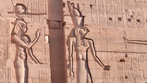details of ancient hieroglyphs on a wall in an ancient temple philae in aswan, egypt.