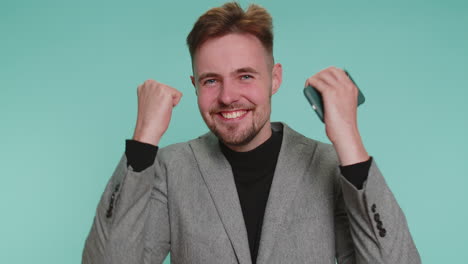 happy businessman celebrating success on his phone