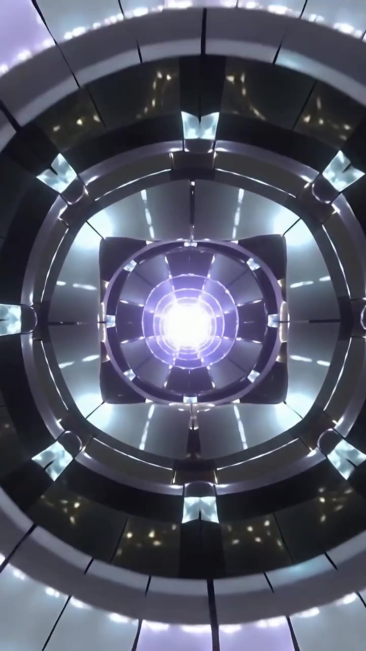 Video verticale: Inclinando la telecamera si rivelano un nucleo luminoso, anelli LED e pannelli a specchio nell'atrio.