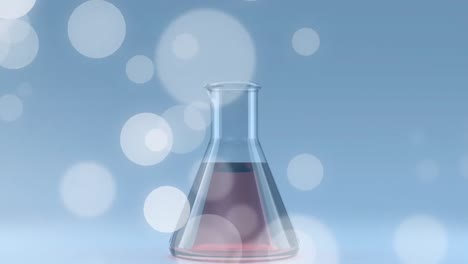 Animation-of-lens-flares-and-liquid-filled-conical-beaker-against-blue-background