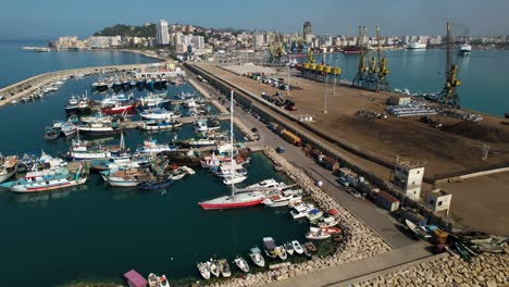 port of durres in albania with anchored ships, yachts and fishing boats on summer