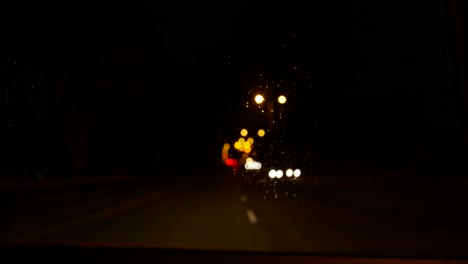 travelling in a car at night - rain - headlights - streetlights