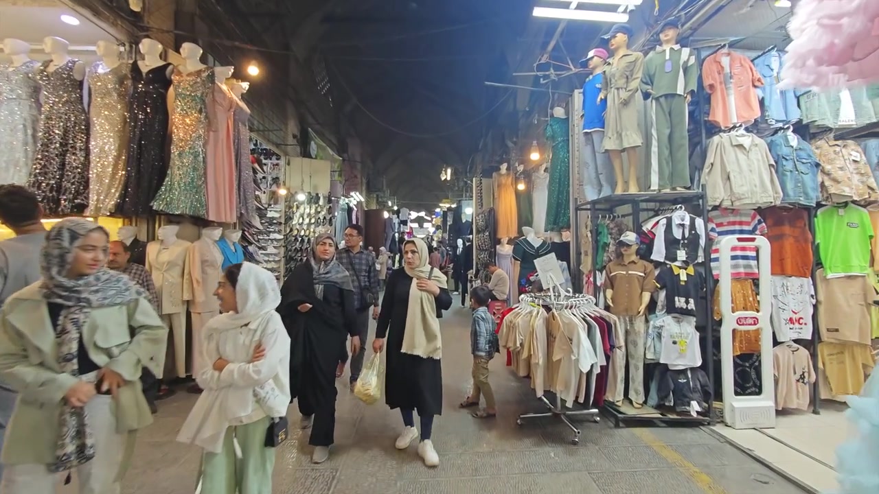 People Walking Through a Bustling Traditional Bazaar at Night