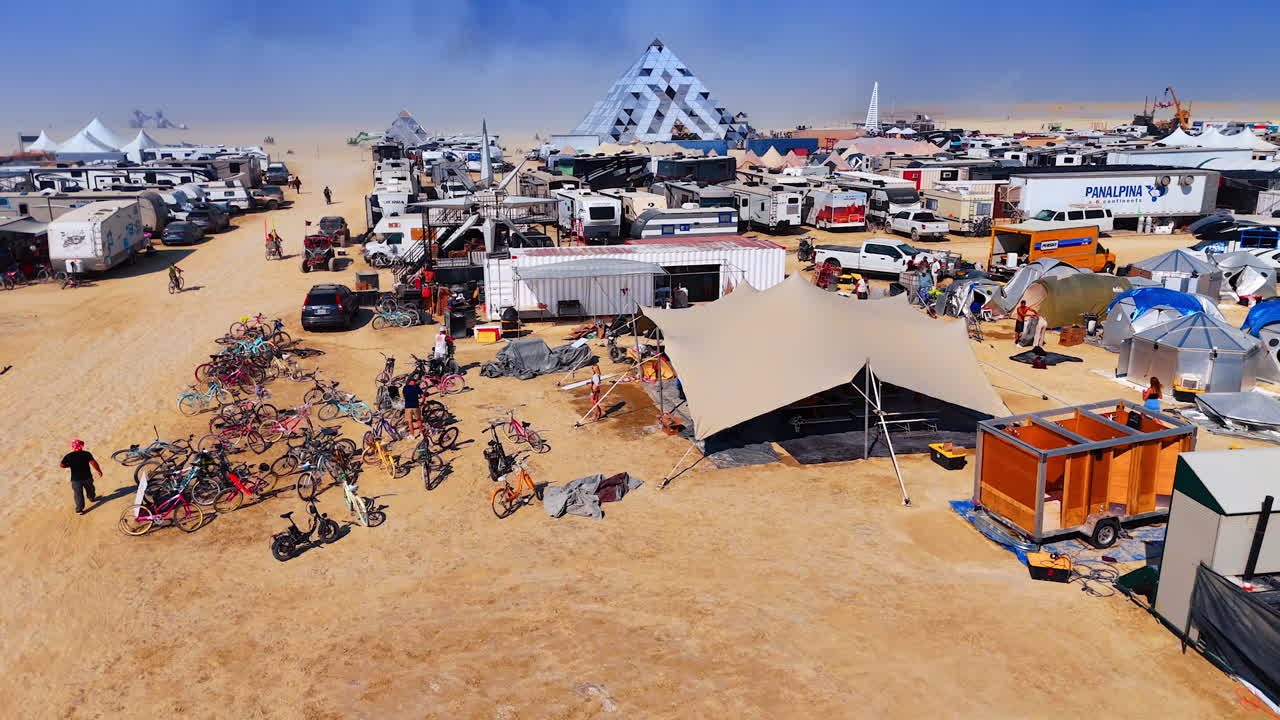 Nevada, USA, 25 August 2025: Aerial view of the Burning Man camp with flags, tents, and pyramids under a bright blue sky