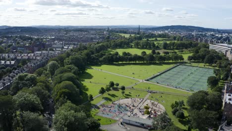 A-high-aerial-shot-moving-across-the-meadows-in-Edinburgh,-on-a-sunny-Summer-day