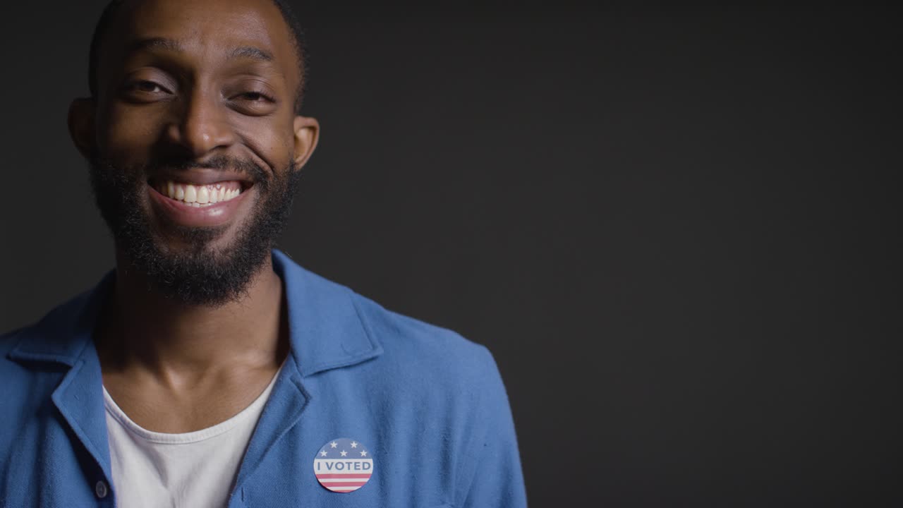 Portrait Of Man With I Voted Sticker On Shirt In American Election