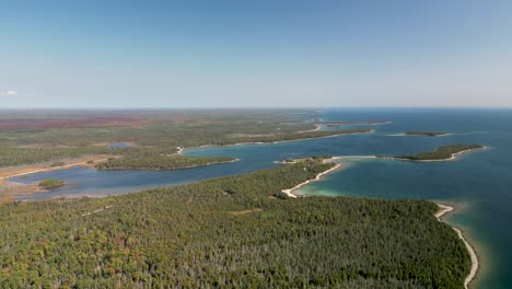 Aerial-view-of-les-cheneaux-islands-and-forested-coastline,-lake-huron,-michigan-high-altitude