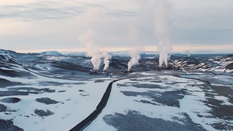 smoking geothermal plant in frozen volcanic landscape, krafla, iceland