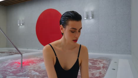 woman relaxing in a modern spa hot tub