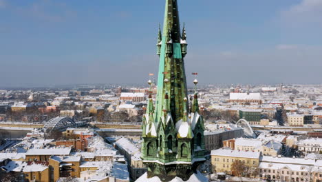 panorama of snow covered podgorze district with tenement houses (with st. joseph's church tower) with central view of wawel castle in krakow, poland