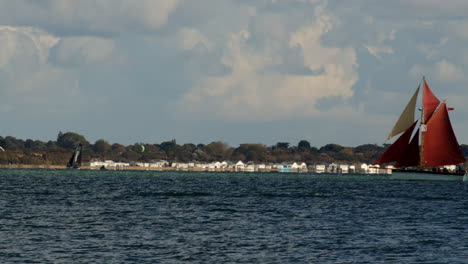 a gaff cutter called golden vanity sails in and out of frame with weston in background