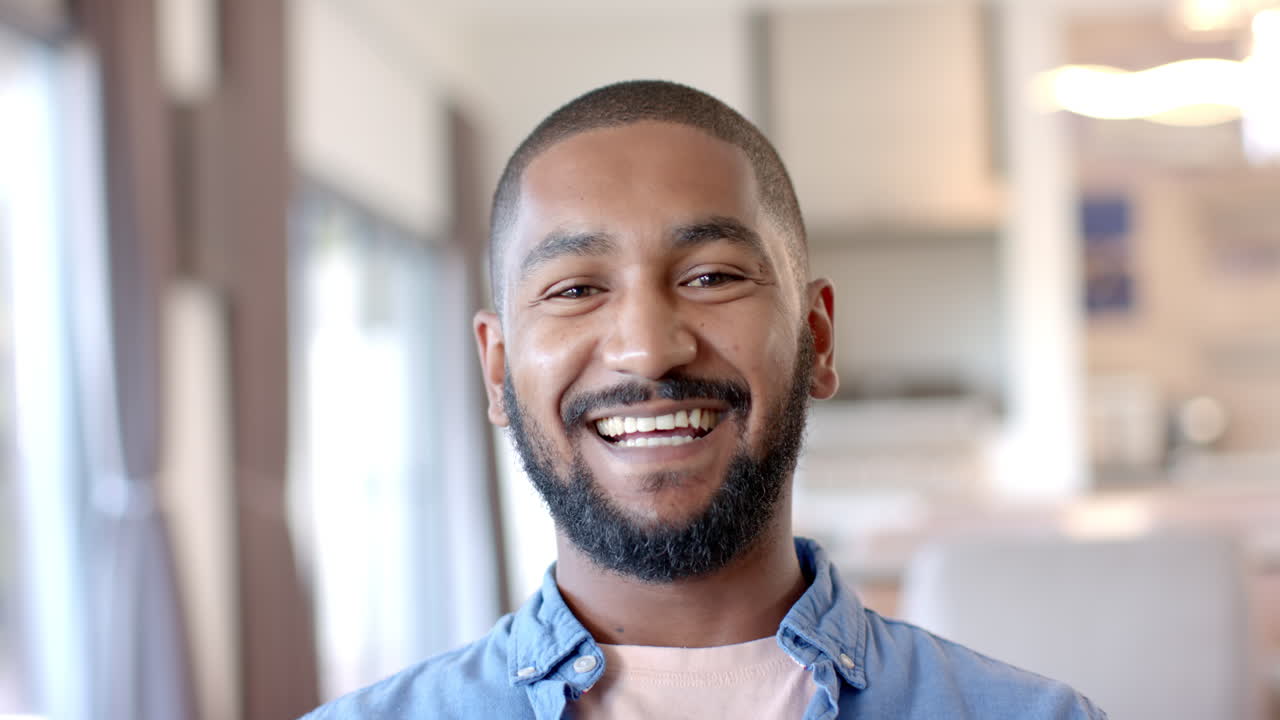 Smiling man enjoying time at home, radiating happiness and warmth