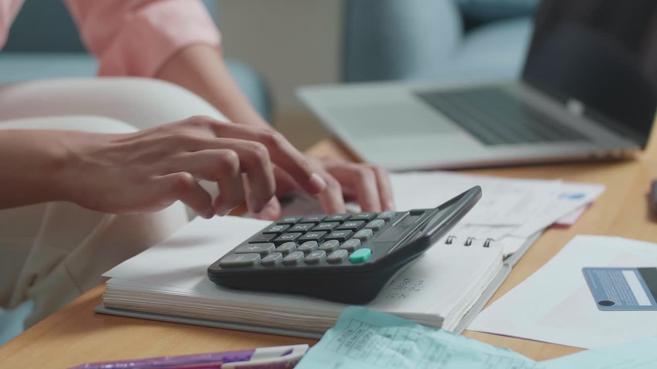 Close Up Of Woman'S Hand With The Bill Calculating Money By Calculator