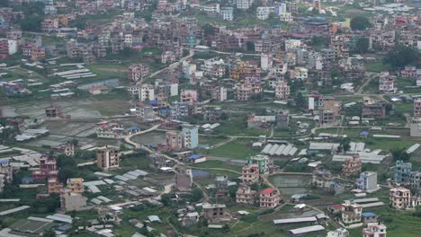 A-panning-aerial-view-of-the-city-of-Kathmandu,-Nepal-on-a-cloudy-day-at-the-beginning-of-rainy-season