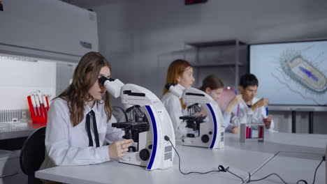 students conduct a biology experiment in a science lab.