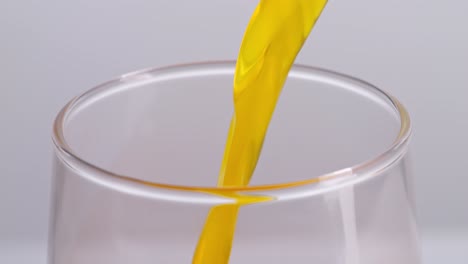 orange juice pouring into a glass