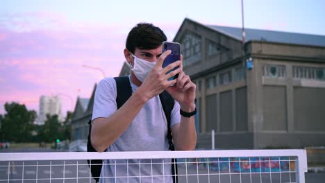 adult man wearing protective mask capturing a view near port of puerto ingeniero white in buenos aires, argentina