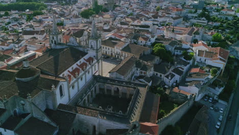 aerial orbiting shot over portalegre cathedral revealing historic cityscape, alentejo