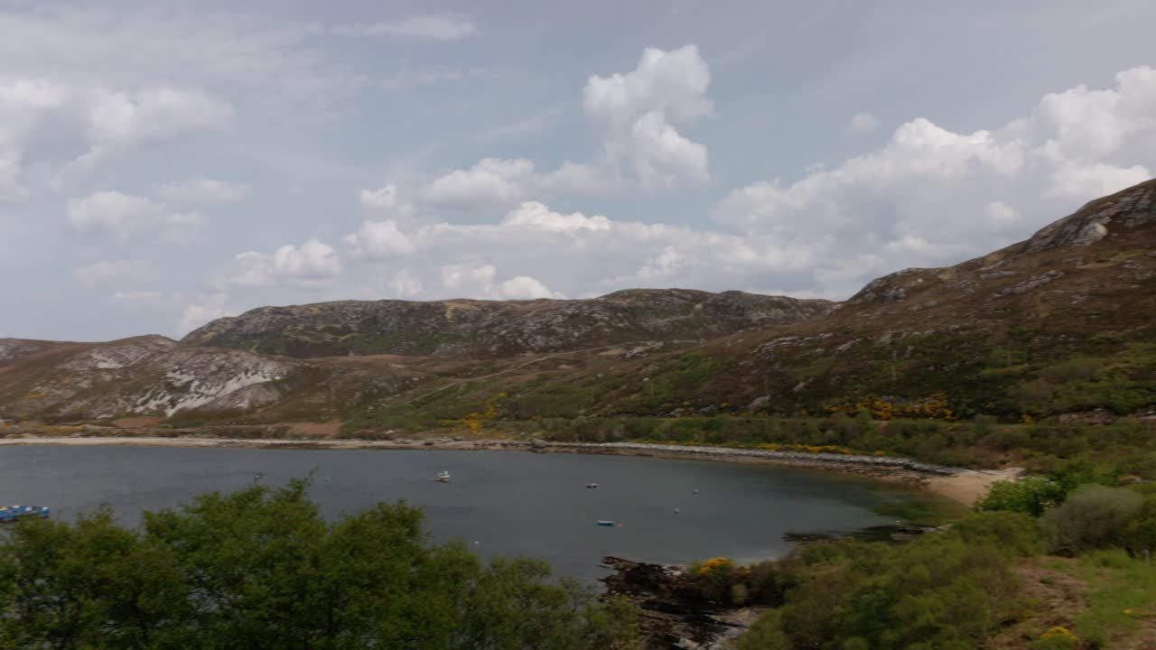 slow panning shot revealing a fish farm in the sea in the Scottish Highlands