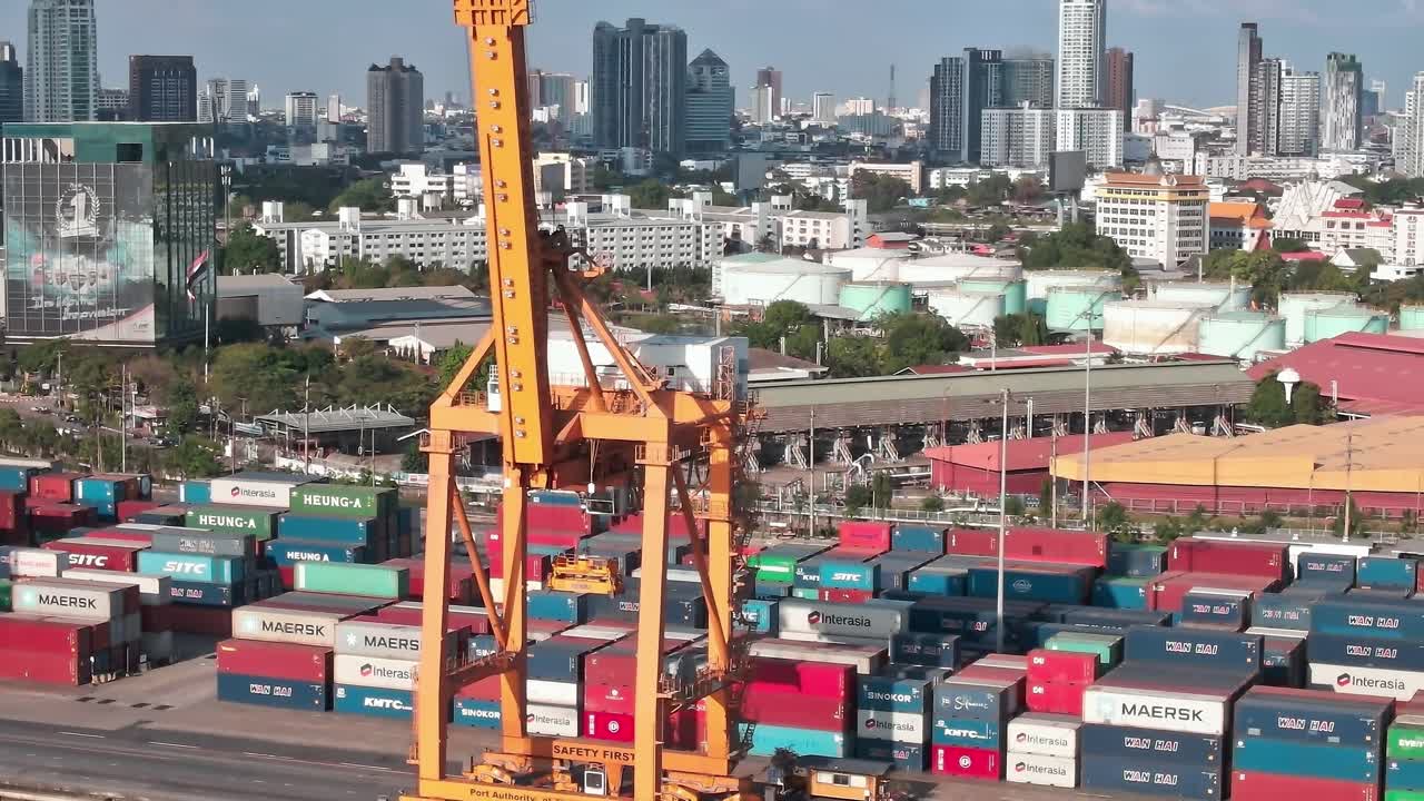 View of shipping containers and city skyline in Bangkok during daytime