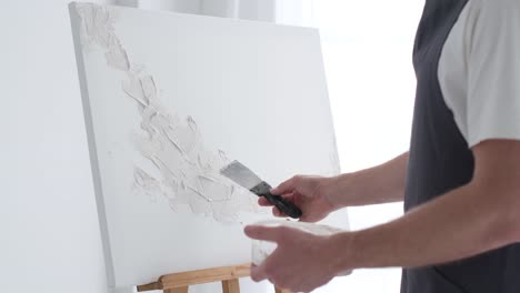 creating textured art on canvas with a spatula