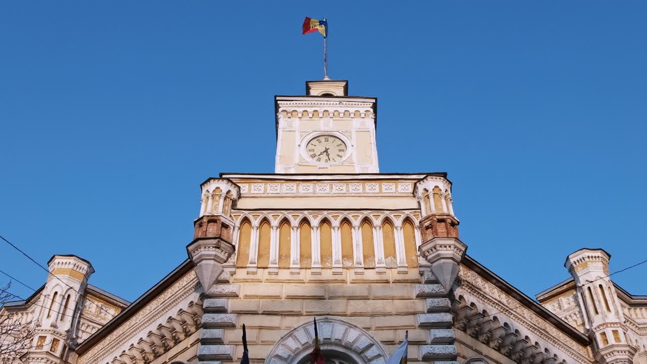 CHISINAU, MOLDOVA - AUGUST 28, 2018: Close-up shot of the City Hall and national flags at sunset