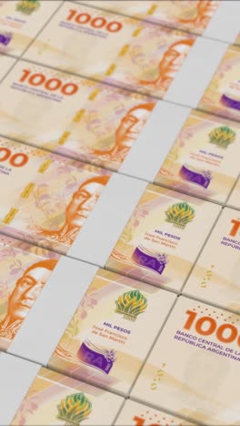 vertical video of 1000 argentine peso banknotes printed by a money press