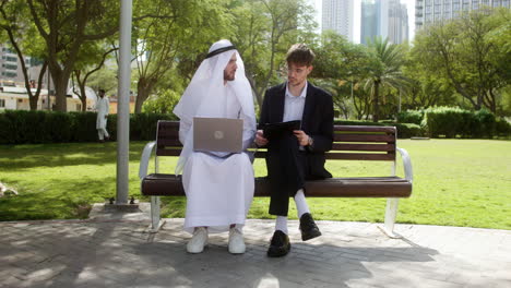 Men-sitting-on-the-bench-of-a-park