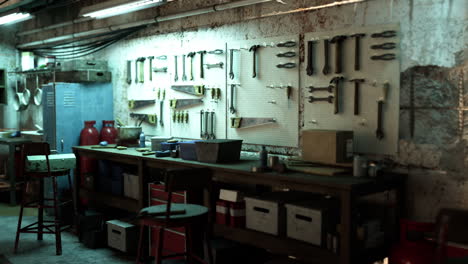 a cluttered garage with a workbench full of tools.